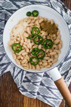 beans and green peppers in a white bowl