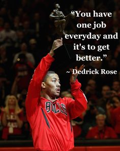 a man holding up a trophy in front of a crowd with a quote on it