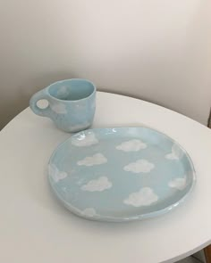 a cup and saucer sitting on top of a white table