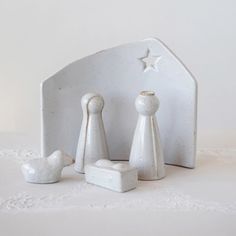 three white ceramic figurines sitting next to each other