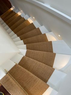 there is a carpeted stair case in the middle of a room with white walls