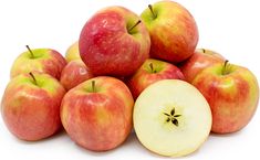 a pile of red and green apples sitting next to each other on a white surface