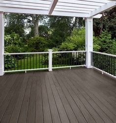 an outdoor deck with black railing and wood siding