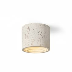 a light that is on the side of a white wall mounted fixture with a wooden base