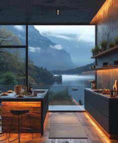 a kitchen with an open floor plan and mountains in the backgroung area