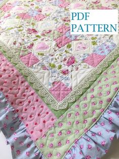 a pink and green quilted blanket on top of a white tablecloth with the words pdf pattern