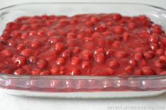 a casserole dish with red fruit in it