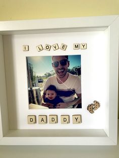 a photo frame with scrabbles and words that spell out i love my daddy