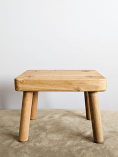 a wooden bench sitting on top of a carpeted floor