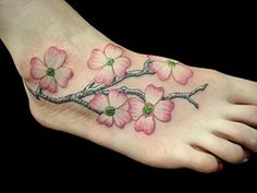 a foot with pink flowers on it and a tree branch in the middle of it