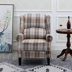 a plaid chair next to a small table with a wine bottle and glass on it