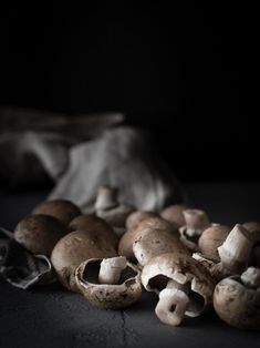 mushrooms are sitting on the ground in front of a cloth