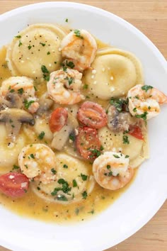 a white plate topped with ravioli shrimp scamps