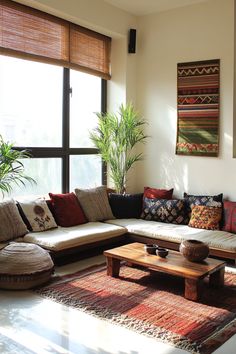 a living room filled with lots of furniture next to a large window and potted plant