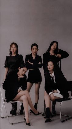 four women in black dresses sitting on chairs