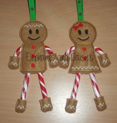 two gingerbread man ornament with candy canes