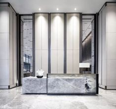 an elegant lobby with marble counter tops and walls