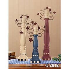 three wooden candlesticks with stars on them