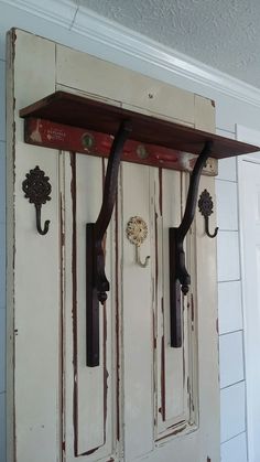 an old door with some hooks on it