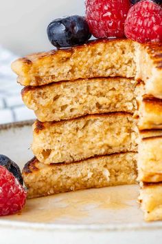 a stack of pancakes with fresh berries on top