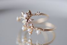 About A romantic work of architectural beauty, the Sugar Plum Fairy ring was directly inspired by the beautiful Russian prima ballerina Nina Kaptsova during her performance of the "Dance of the Sugar Plum Fairy". As twinkling and delectably lovely as the dainty sprite herself, dancing from one dew-dropped flower petal to another, this graceful ring is an homage to the delicate filigree of movements in her dance. Description Made by hand in our Montreal studio Available in 14k gold Featuring 1 2. Fairy Rings, Sofia Zakia, Fairy Ring, Prima Ballerina, Sugar Plum Fairy, Fairy Wedding, Hot Jewelry, Flower Petal, Alternative Engagement Rings