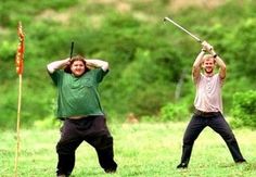 two men are holding up their swords in the grass