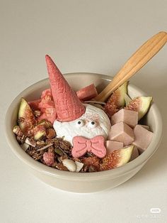 a bowl filled with assorted candies and an elf's head sticking out of it