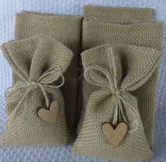 two small bags with hearts tied to them