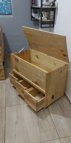 an open wooden box sitting on the floor