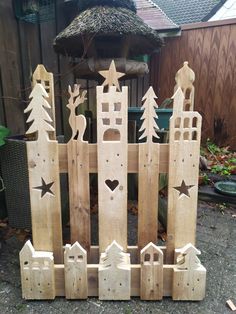 a wooden fence made out of wood with trees and stars on it's sides