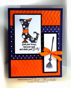 an orange and blue card with a witch's hat, broom, and words on it