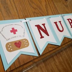 a banner with the words nurse on it hanging from a wooden wall next to a pair of scissors