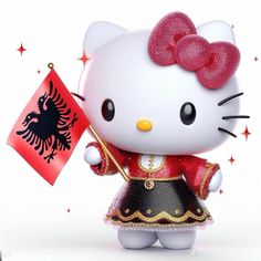 a hello kitty figurine holding a flag and wearing a red dress with gold trim