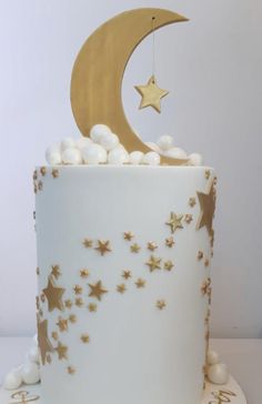 a white cake with gold stars and a crescent on top