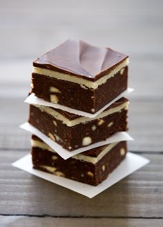 three pieces of cake sitting on top of each other in front of a wooden table