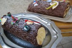 there is a large piece of chocolate cake on the tray and another half has been decorated with candles