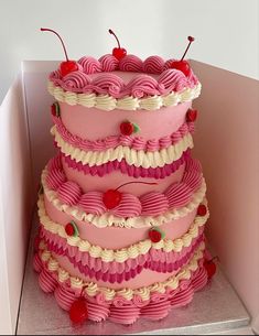 a three tiered cake with cherries on top