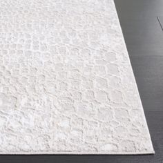 a white rug on the floor in a room