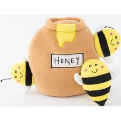 a stuffed honey jar with two bees on it and the words honey written on its side