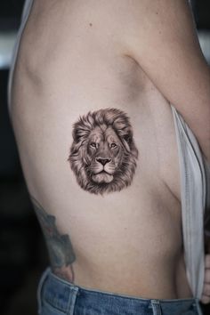 a man with a lion tattoo on his chest