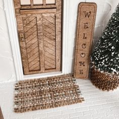 a welcome mat next to a wooden door