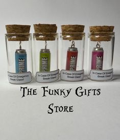 the funky gifts store has four glass bottles with corks in them, each filled with different colored items