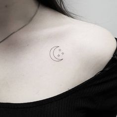 a woman's shoulder with a crescent and stars tattoo on the left side of her chest