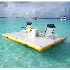 two lounge chairs sitting on top of an inflatable raft floating in the ocean