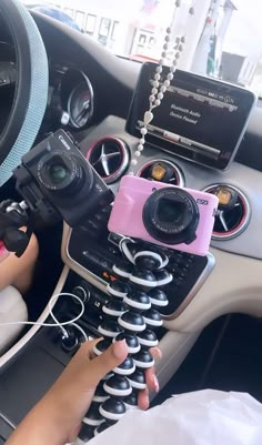 a person holding a camera in their car