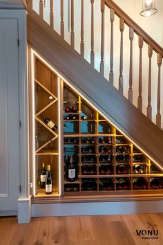 under the stairs is a wine rack with bottles