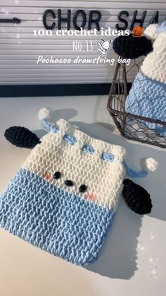 there is a crocheted cell phone case that looks like a sheep in blue and white