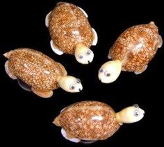 four little turtle figurines are shown in the shape of three turtles with their heads turned to look like they're swimming