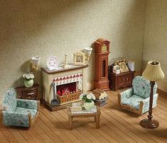 a doll house living room with furniture and accessories on the floor, including a fireplace