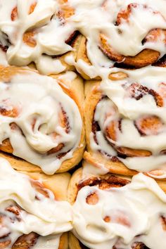 cinnamon rolls with icing sitting on top of each other